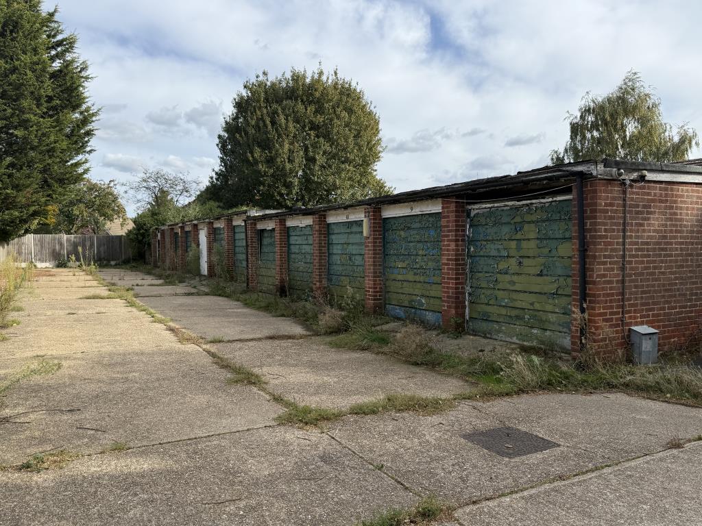 Lot: 4 - COMPOUND OF TWENTY GARAGES AND LAND IN NEED OF REFURBISHMENT TOGETHER WITH AN AREA OF AMENITY LAND - One compound of garages in village